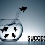 Success Motivational Quotes: A fish breaking its limits by jumping from a flask to fly